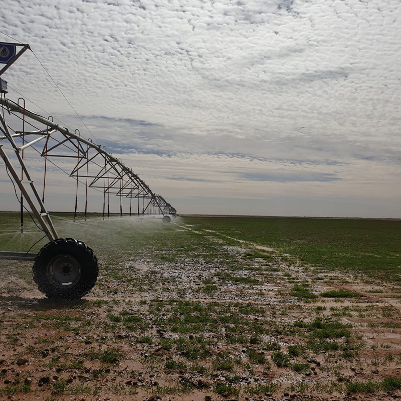 Skief Pivot irrigation system watering crops on red soil